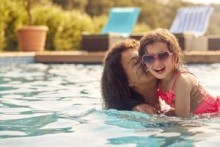 Mother and daughter in swimming pool