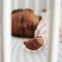 Infant sleeping in crib