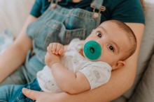 Baby with pacifier in mouth