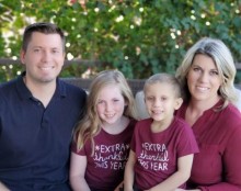 Family of 4 posing on a bench