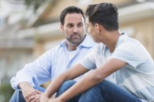 Father and teen son talking