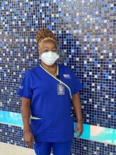 Masked provider in blue scrubs