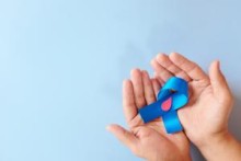 Two hands holding a blue ribbon