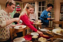 Family filling their plates at buffet table