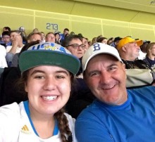 Teen and father at baseball game