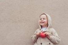 Child holding a small red ball