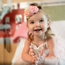 Toddler girl in fancy dress with flowers on her head