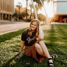 Teen girl sitting in the grass