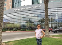 Girl standing in front of hospital