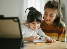 Mother helping child with homework