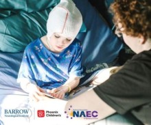 Child in hospital bed with netting on head