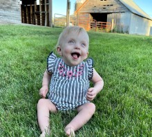 Baby girl sitting in the grass