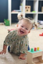 Toddler on floor, playing with toys