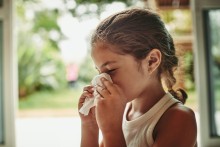 Girl blowing her nose