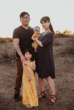 Family photo of mother, father and two young children in desert