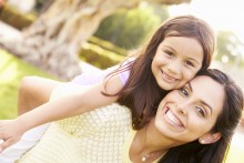 Mother and daughter piggyback