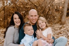 Family of 4 posing in the leaves