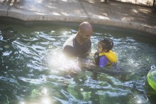 Father and daughter in swimming pool