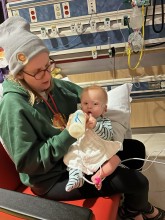 Mother holding infant in hospital