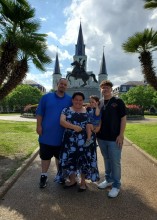 Family of 4 posing in courtyard