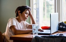 Child studying at home with laptop