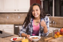 Young female athlete eating healthy breakfast