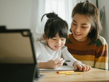 Mother helping child with homework