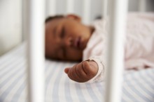 Infant sleeping in crib