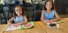 Two girls in glasses, coloring