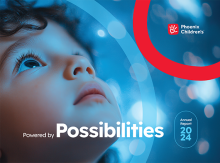Child looking up with font below "Powered by Possibilities"