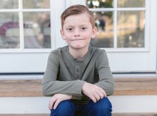 Young boy sitting on steps
