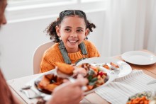Girl smiling at dinner table