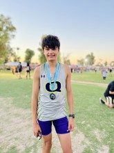 Teen boy smiling and wearing medal