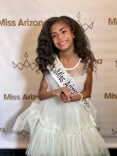 Girl in pageant dress and sash