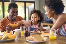 Child and parents eating breakfast