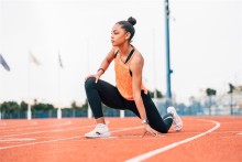 Runner stretching on track